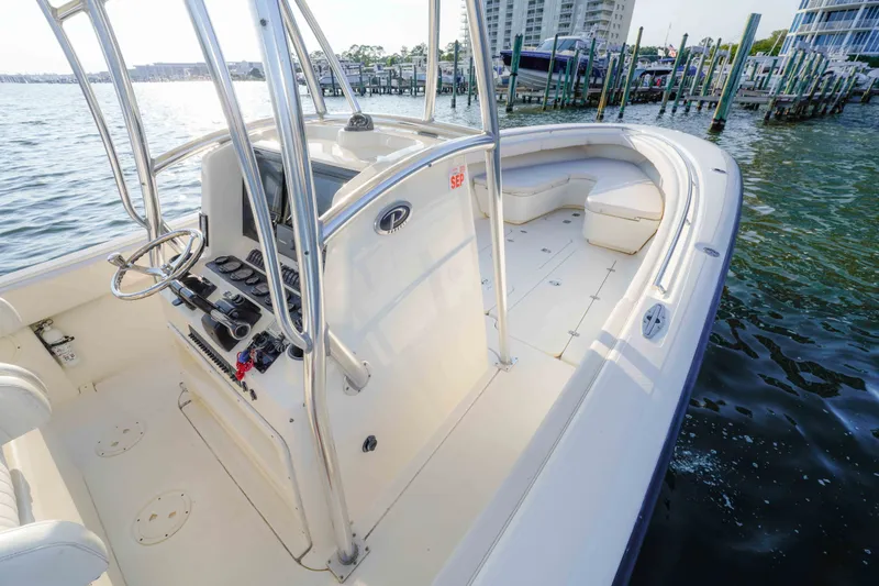 Slide: The Image of 2005 Pursuit 3480 Center Console boat docked, featuring spacious deck and modern controls. - 29