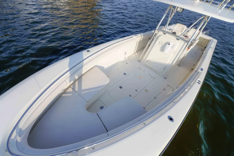Slide: The Image of 2005 Pursuit 3480 Center Console boat on water, showcasing spacious deck and sleek design. - 36