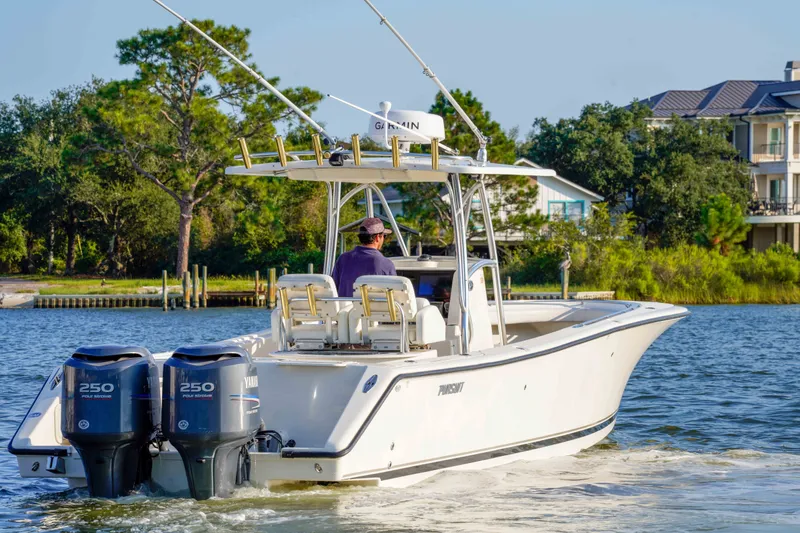Slide: The Image of 2005 Pursuit 3480 Center Console boat cruising on a scenic waterway. - 14