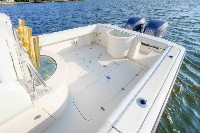 Slide: The Image of 2005 Pursuit 3480 Center Console boat with dual Yamaha engines on open water. - 18