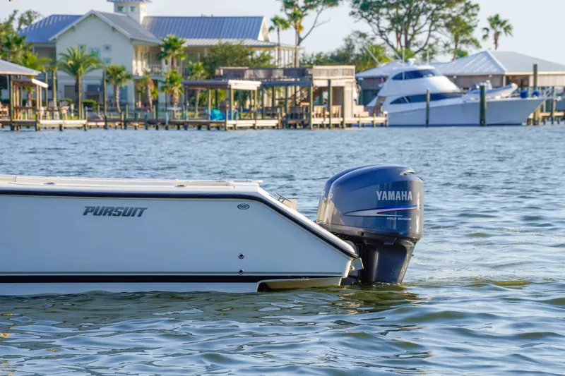 Slide: The Image of 2005 Pursuit 3480 Center Console boat with Yamaha engine on calm water near docks. - 9