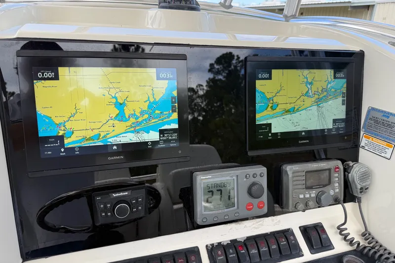 Slide: The Image of Control panel of a 2005 Pursuit 3480 Center Console with navigation screens and instruments. - 43