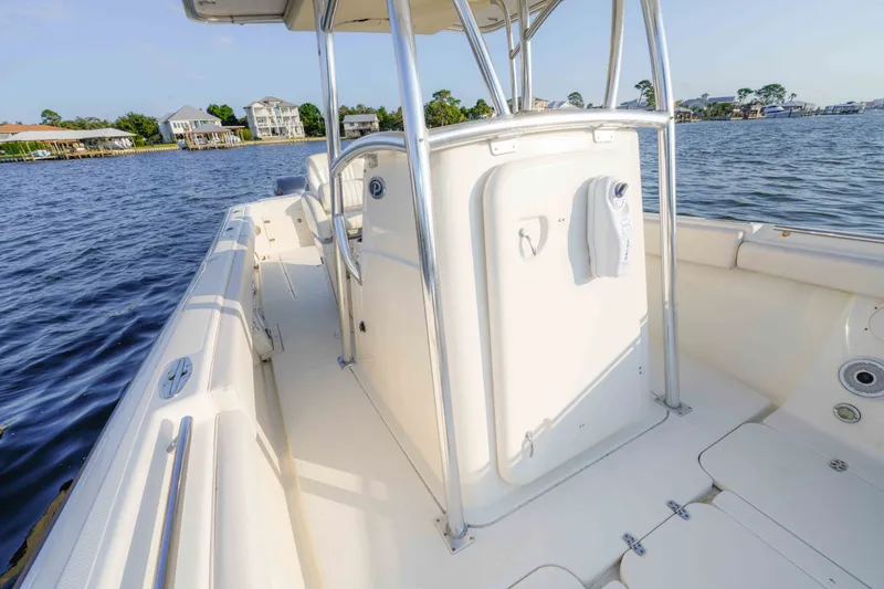 Slide: The Image of 2005 Pursuit 3480 Center Console boat on calm water, showcasing spacious deck and sleek design. - 38