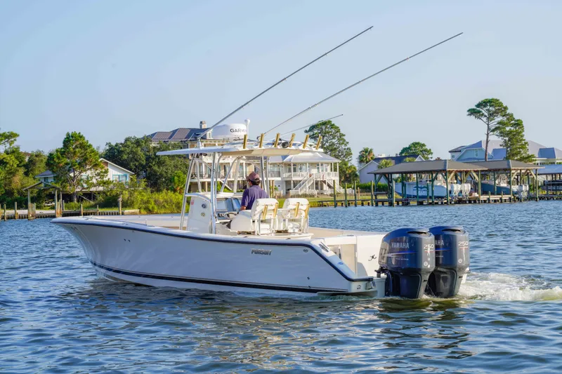 Slide: The Image of 2005 Pursuit 3480 Center Console boat cruising on a scenic waterway. - 12