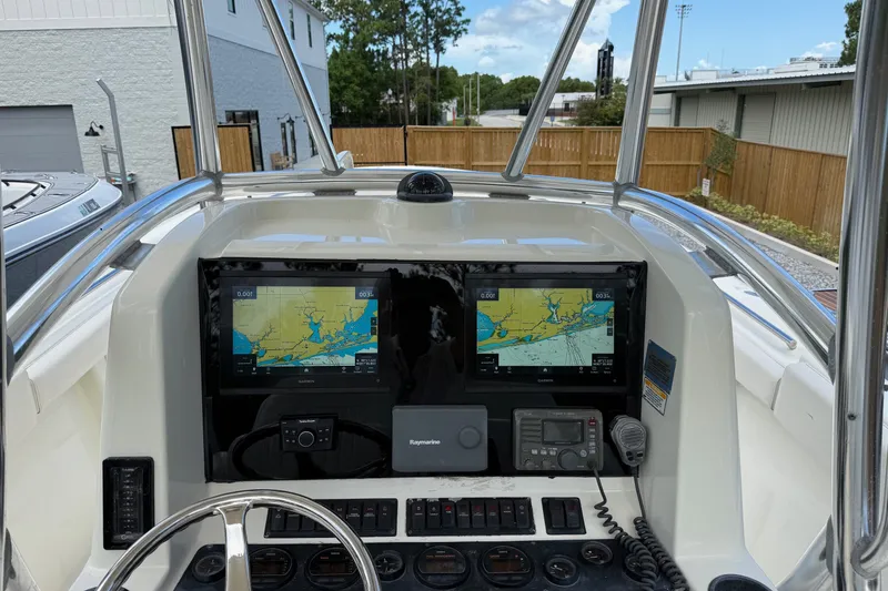 Slide: The Image of 2005 Pursuit 3480 Center Console boat dashboard with dual Garmin navigation screens. - 42