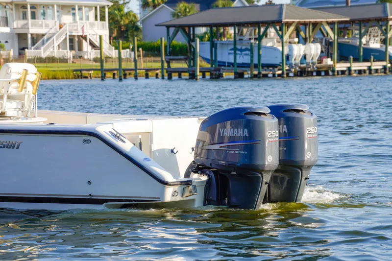 Slide: The Image of 2005 Pursuit 3480 Center Console boat with twin Yamaha 250 engines on water. - 10