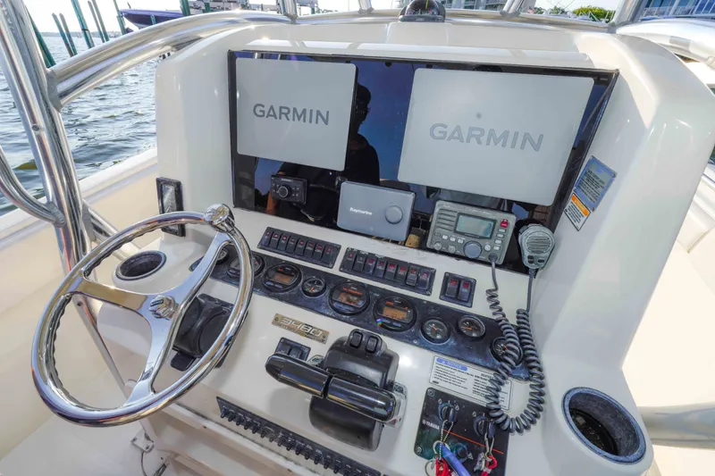 Slide: The Image of 2005 Pursuit 3480 Center Console boat dashboard with Garmin navigation system. - 41