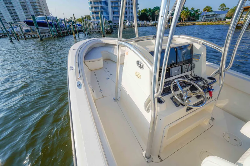 Slide: The Image of 2005 Pursuit 3480 Center Console boat docked, featuring steering console and waterfront view. - 28