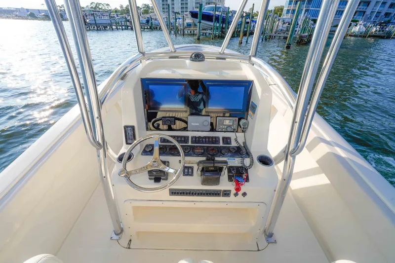 Slide: The Image of 2005 Pursuit 3480 Center Console boat helm with steering wheel and navigation equipment. - 27
