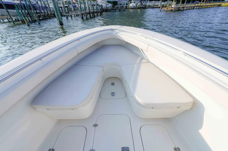 Slide: The Image of 2005 Pursuit 3480 Center Console boat interior with cushioned seating and storage compartments. - 33