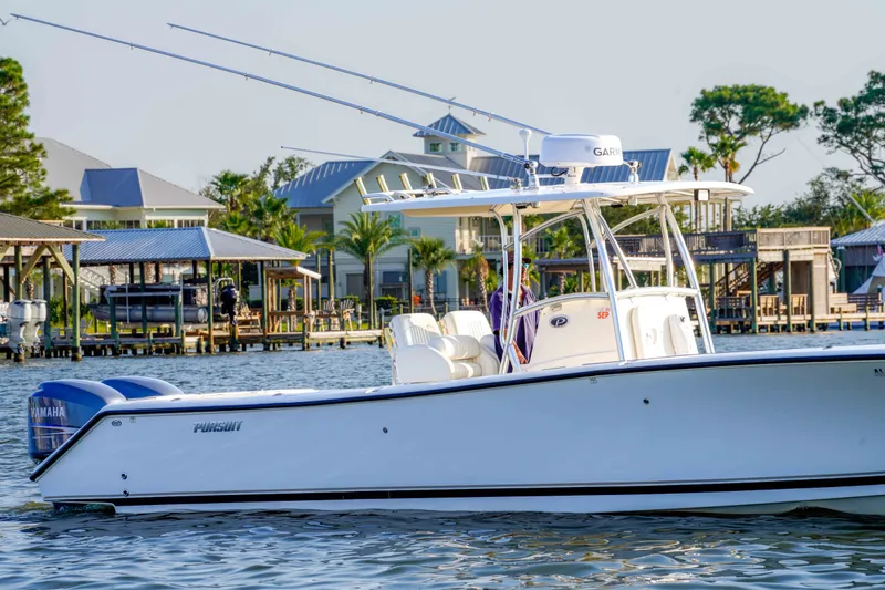 Slide: The Image of 2005 Pursuit 3480 Center Console boat on water near waterfront homes. - 11