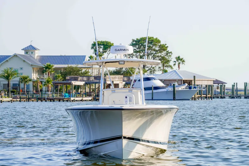 Slide: The Image of 2005 Pursuit 3480 Center Console boat on water near docks and waterfront homes. - 5