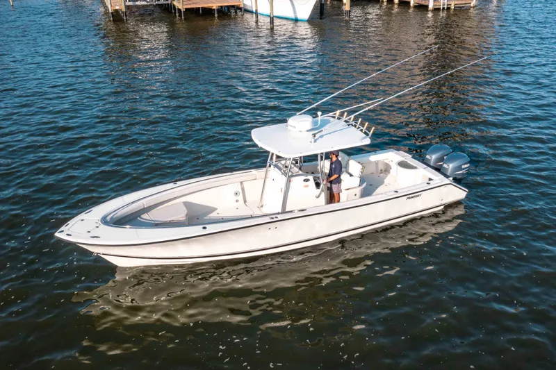 Slide: The Image of 2005 Pursuit 3480 Center Console boat on water, featuring dual outboard engines. - 46