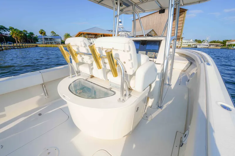 Slide: The Image of 2005 Pursuit 3480 Center Console boat with spacious deck and fishing rod holders. - 23