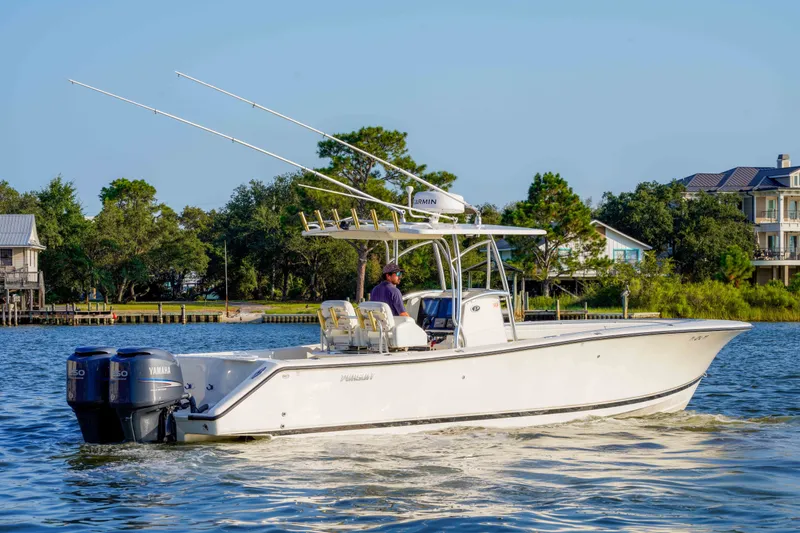 Slide: The Image of 2005 Pursuit 3480 Center Console boat cruising on a scenic waterway. - 16