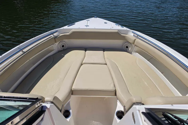 Slide: The Image of 2021 Pursuit DC 266 Dual Console boat with beige seating, on calm water. - 20