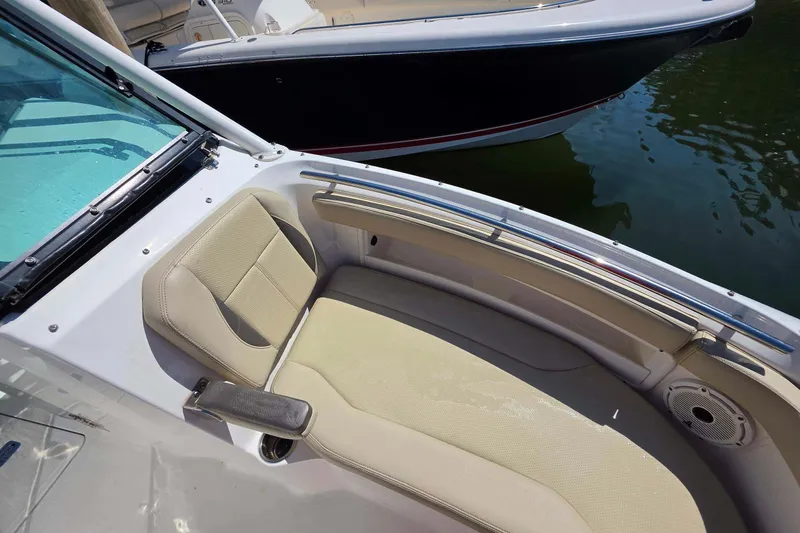 Slide: The Image of 2021 Pursuit DC 266 Dual Console boat interior with beige seating and sleek design. - 22