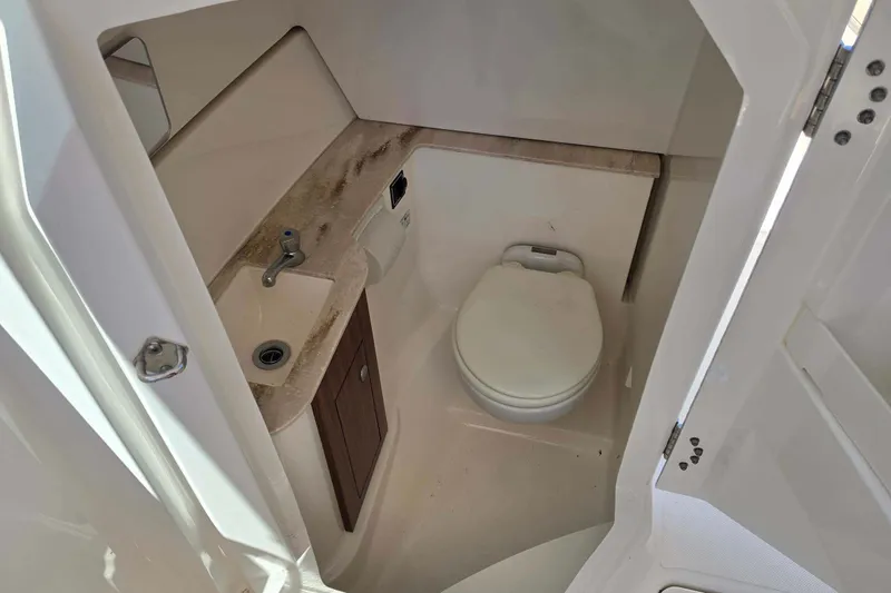 Slide: The Image of 2021 Pursuit DC 266 Dual Console boat bathroom with sink and toilet. - 17