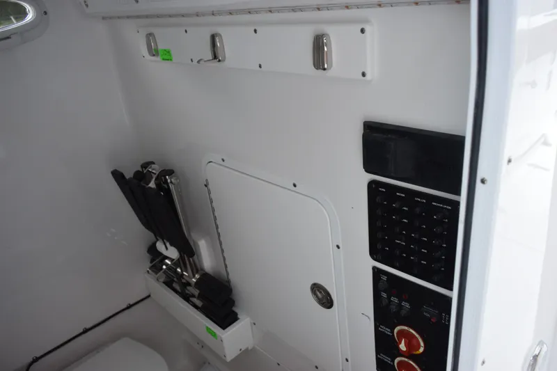 Slide: The Image of Interior view of 2027 Sea Hunt Ultra 285SE boat with control panel and storage. - 17