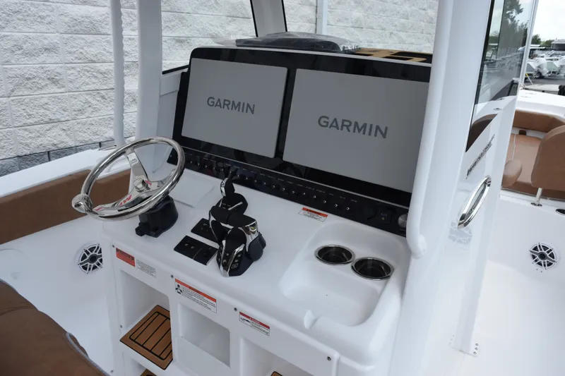 Slide: The Image of 2027 Sea Hunt Ultra 285SE boat dashboard with dual Garmin displays and steering wheel. - 10