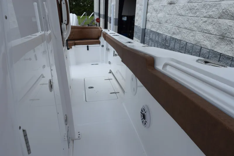 Slide: The Image of Interior view of 2027 Sea Hunt Ultra 285SE boat, featuring sleek white and brown design. - 15