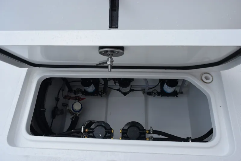Slide: The Image of Open compartment of 2027 Sea Hunt Ultra 285SE boat showing internal components and wiring. - 26