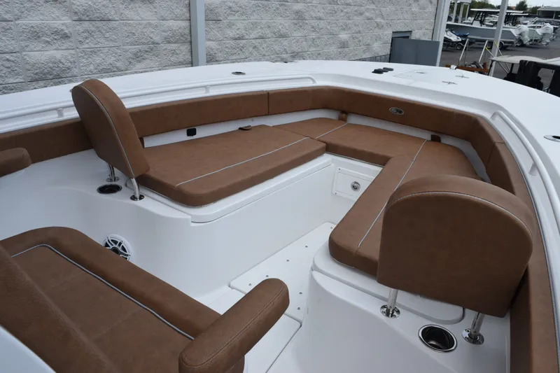 Slide: The Image of 2027 Sea Hunt Ultra 285SE boat interior with brown cushioned seating. - 13