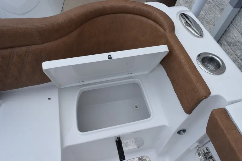 Slide: The Image of Open storage compartment on 2027 Sea Hunt Ultra 285SE boat with brown seating. - 25