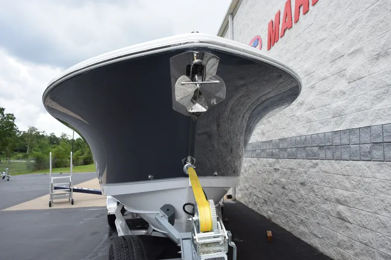 Slide: The Image of 2027 Sea Hunt Ultra 285SE boat on trailer, parked near a building. - 3