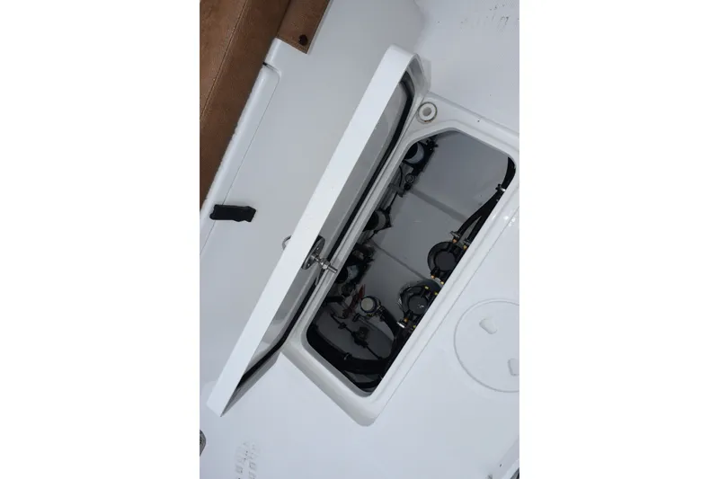 Slide: The Image of Open hatch of 2027 Sea Hunt Ultra 285SE boat, revealing internal components. - 22