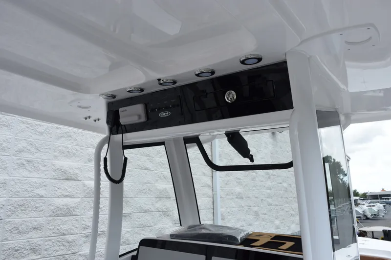 Slide: The Image of 2027 Sea Hunt Ultra 285SE boat console with modern electronics and sleek design. - 11