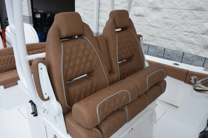 Slide: The Image of Luxurious brown seating on 2027 Sea Hunt Ultra 285SE boat, featuring diamond stitching. - 12