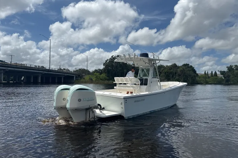 Slide: The Image of 2007 Regulator 26 Classic boat on water under a cloudy sky. - 28
