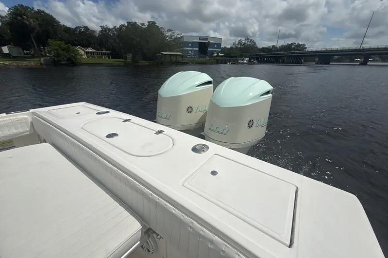 Slide: The Image of 2007 Regulator 26 Classic boat with twin Yamaha engines on a calm river. - 13