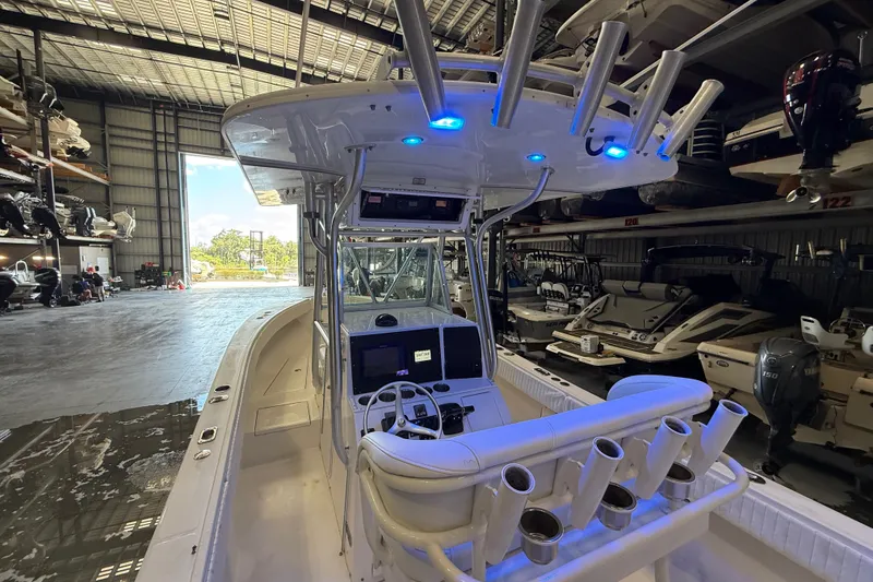 Slide: The Image of 2007 Regulator 26 Classic boat in a storage facility, featuring a modern helm and rod holders. - 19