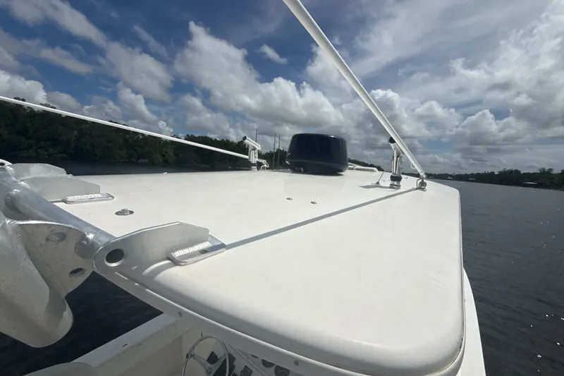 Slide: The Image of 2007 Regulator 26 Classic boat on a calm river under a partly cloudy sky. - 14