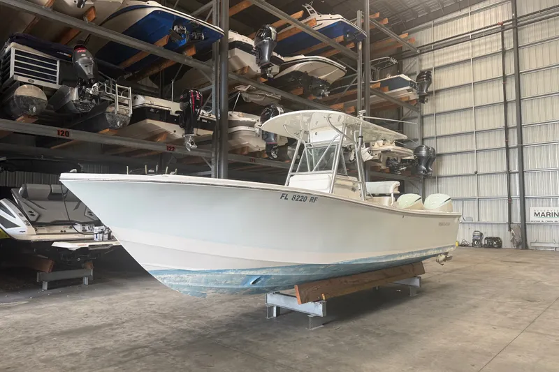 Slide: The Image of 2007 Regulator 26 Classic boat stored indoors on a rack in a marina. - 16