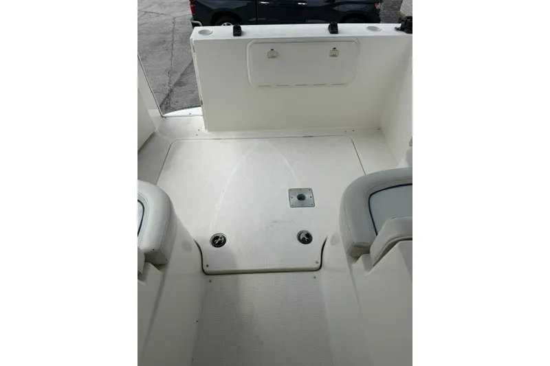Slide: The Image of 2007 Bayliner Discovery 246 boat interior with clean white deck and seating area. - 13
