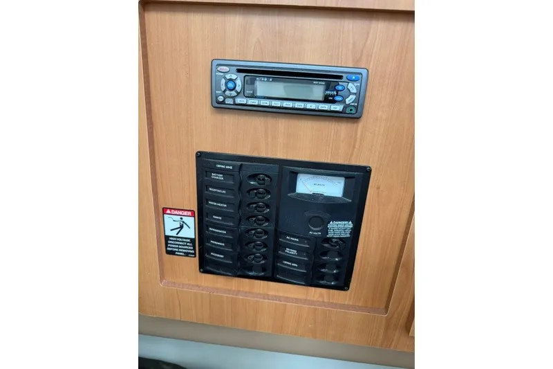 Slide: The Image of 2007 Bayliner Discovery 246 control panel with stereo and electrical switches. - 9