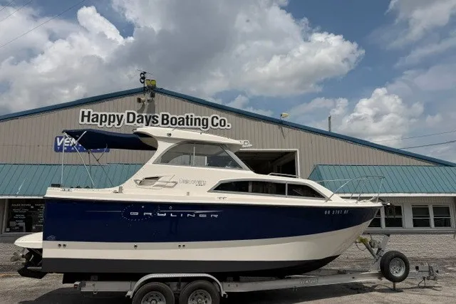 Slide: The Image of 2007 Bayliner Discovery 246 boat on trailer at Happy Days Boating Co. dealership. - 1