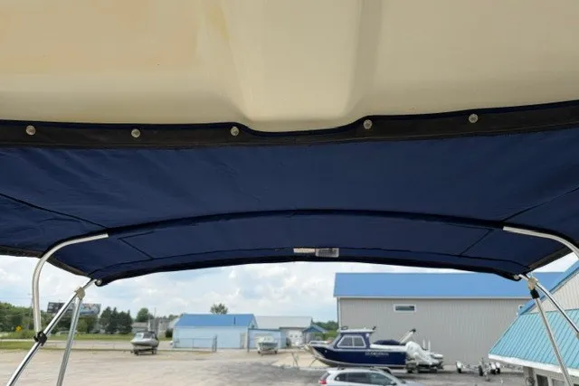 Slide: The Image of 2007 Bayliner Discovery 246 boat canopy with blue fabric and metal frame. - 14