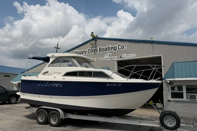 The Image of 2007 Bayliner Discovery 246 boat on trailer at Happy Days Boating Co. dealership. - 0