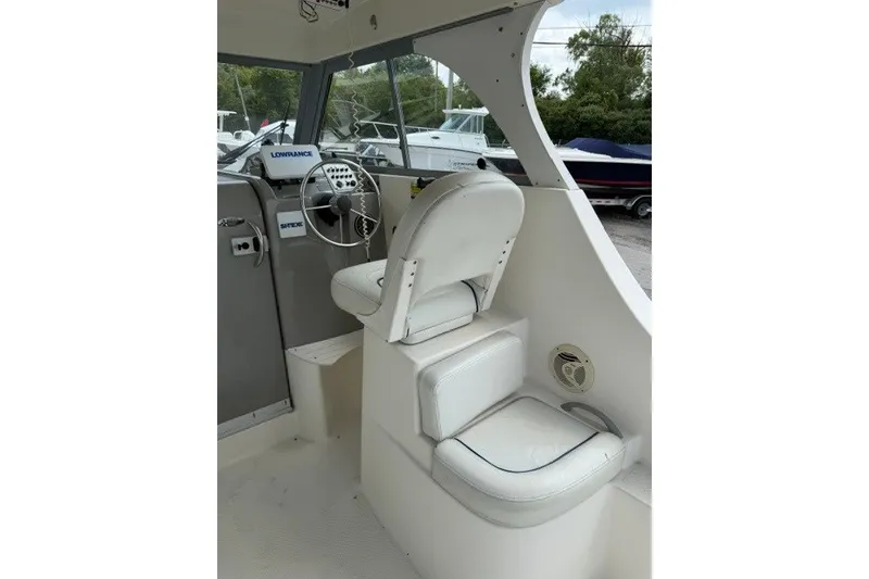 Slide: The Image of Interior of 2007 Bayliner Discovery 246 boat with steering wheel and seating. - 11