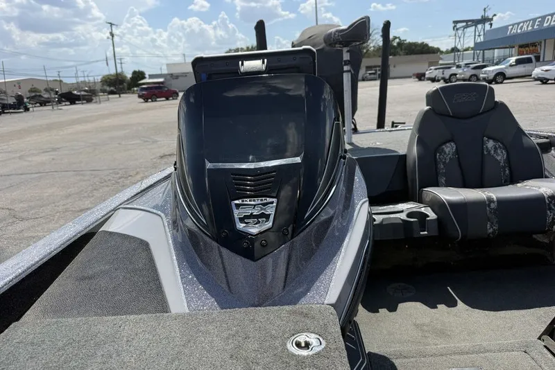 Slide: The Image of 2018 Skeeter FX21 boat with sleek design and comfortable seating in a parking lot. - 5