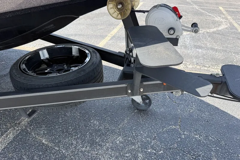 Slide: The Image of 2018 Skeeter FX21 boat trailer with spare tire and winch on asphalt. - 3