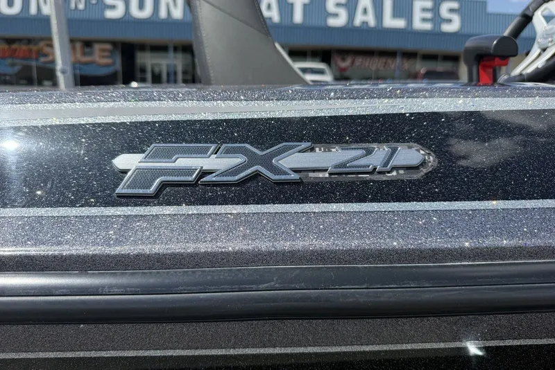 Slide: The Image of 2018 Skeeter FX21 boat emblem with metallic finish at a dealership. - 19