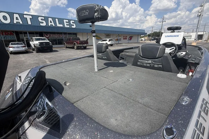 Slide: The Image of 2018 Skeeter FX21 boat at dealership, featuring spacious deck and modern seating. - 9