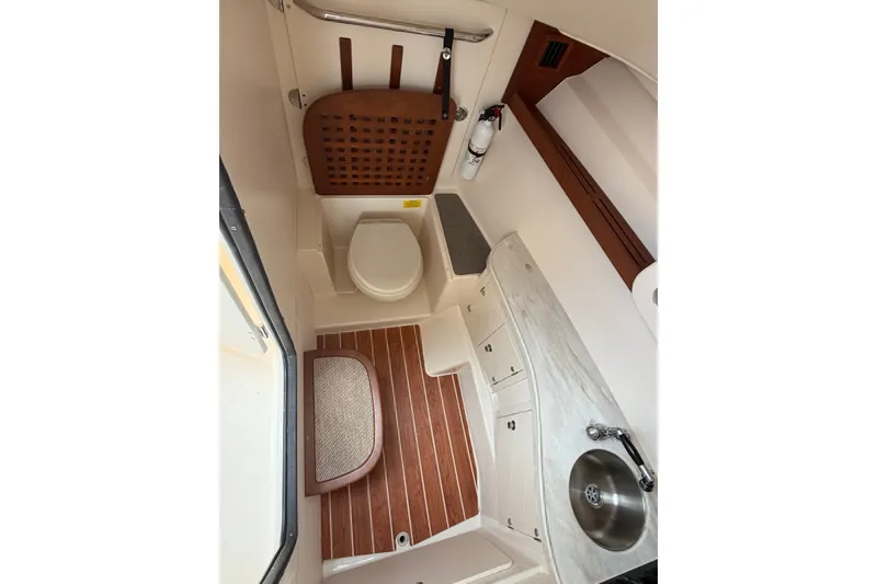 Slide: The Image of Interior of 2017 Grady-White Freedom 335 boat bathroom with sink and toilet. - 15