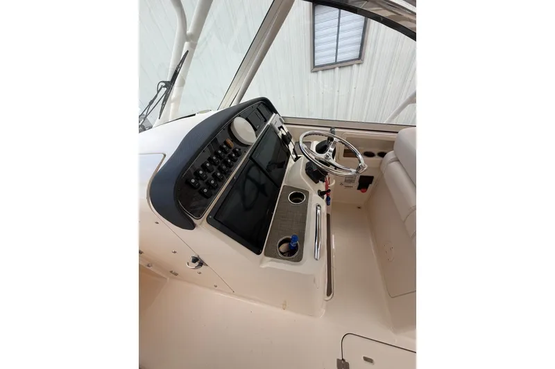 Slide: The Image of 2017 Grady-White Freedom 335 boat helm with steering wheel and control panel. - 21
