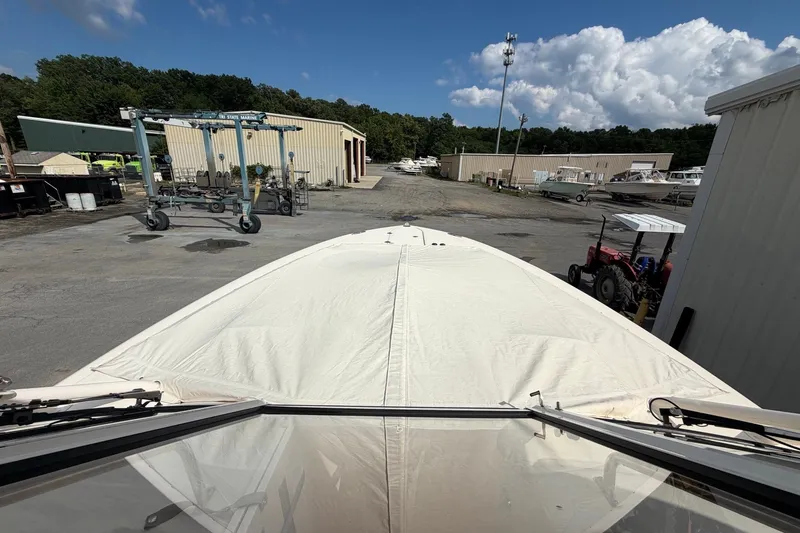 Slide: The Image of 2017 Grady-White Freedom 335 boat in a marina storage area under a clear sky. - 17